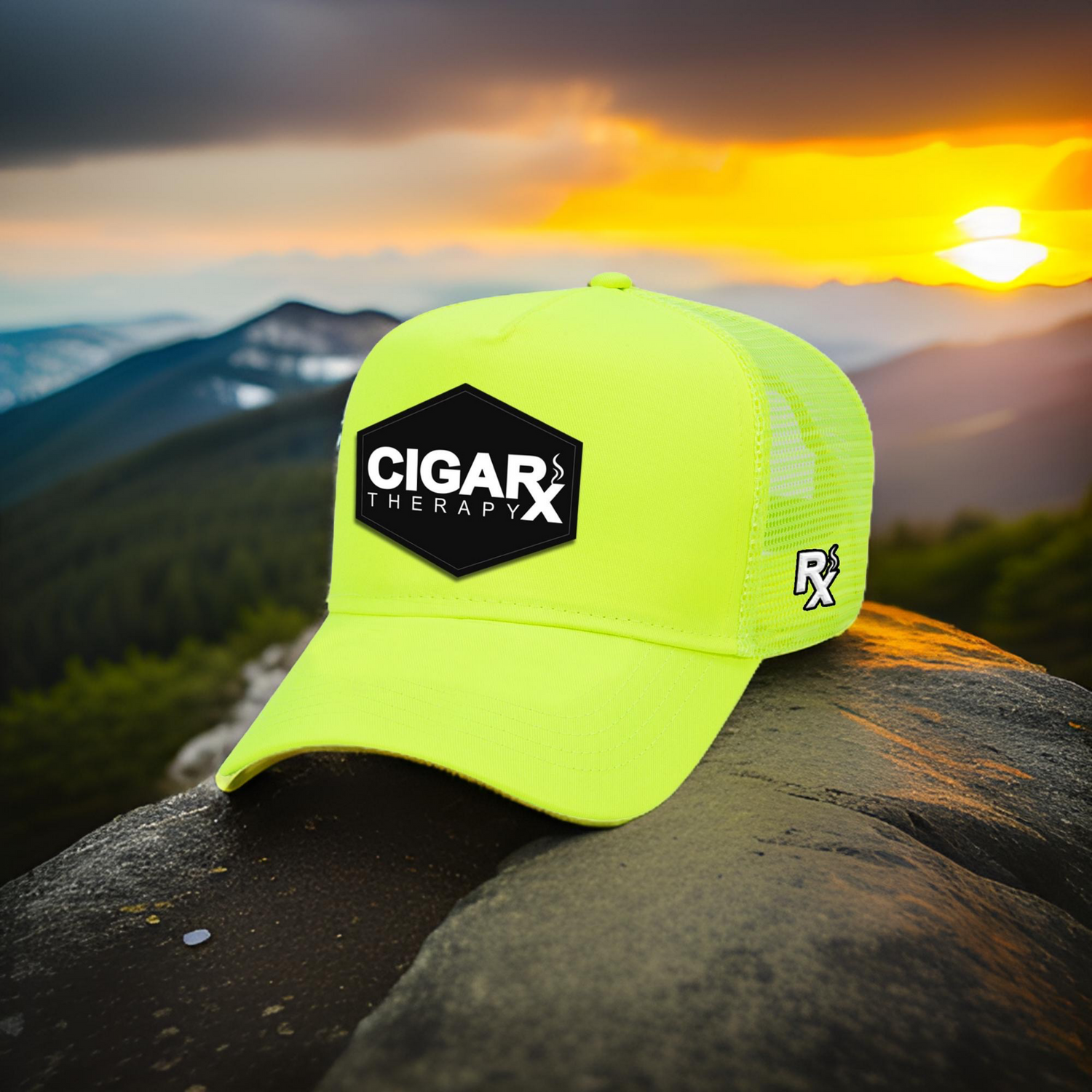 Yellow cap with 'Cigar Therapy' logo on a rock with a sunset in the background